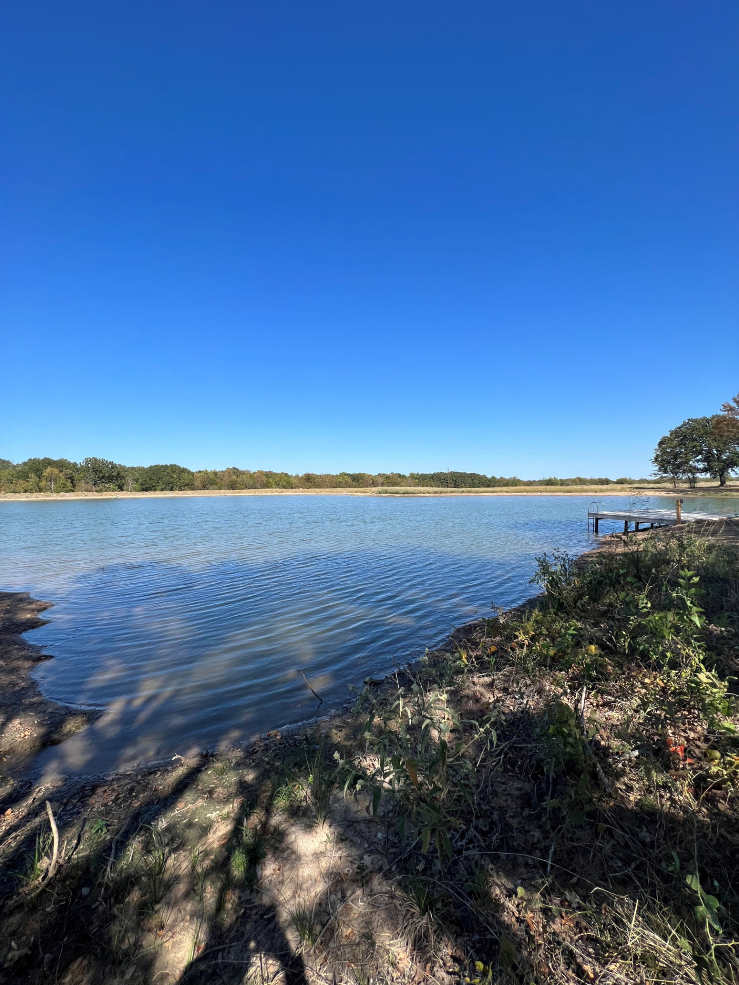 Finished private fishing lake with a dock on Texas property